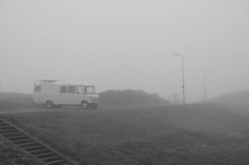 a vintage bus on a foggy day